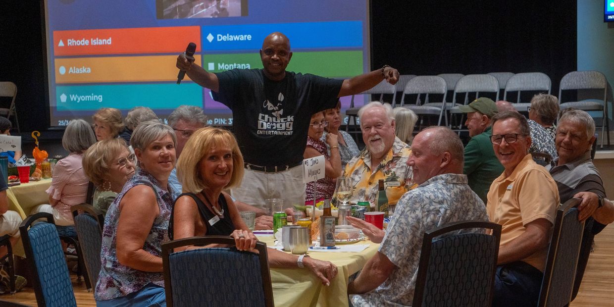 Group at event with man holding microphone.