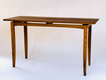 Elegant wooden table with slim legs.