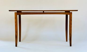 Sleek wooden table with a minimalist design.