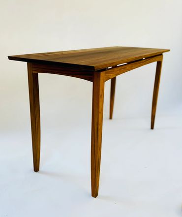 Minimalist wooden table with tapered legs.