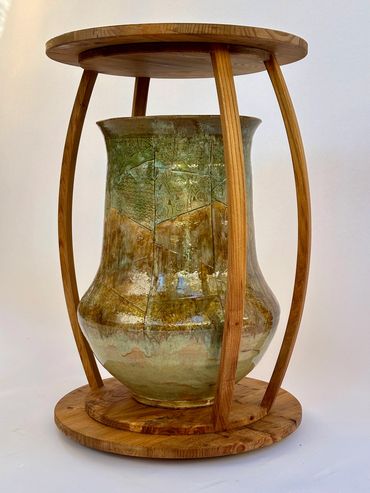 Decorative ceramic vase with wooden stand.