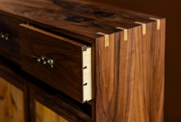 Close-up of a wooden drawer with dovetail joints.
