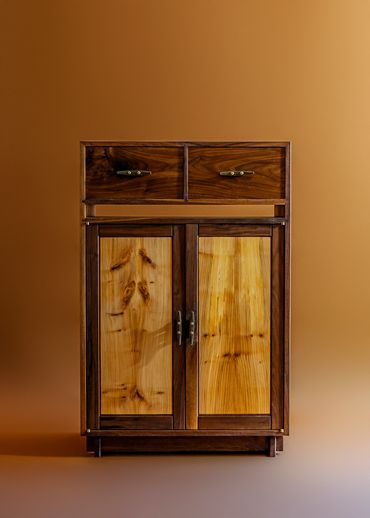 Wooden cabinet with two drawers and double doors.