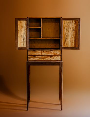 Open wooden cabinet with multiple shelves and drawers.