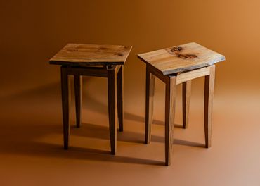 Two wooden stools with natural wood tops.