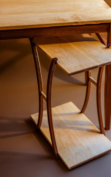 Wooden table with a unique curved base design.