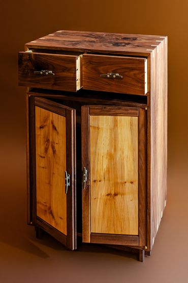 Wooden cabinet with open drawers and doors.