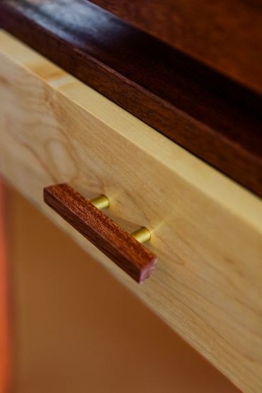 Close-up of a wooden drawer handle.
