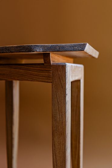 Close-up of a wooden table corner.
