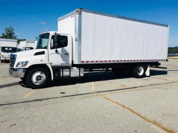 A white box truck parked outside on a sunny day.