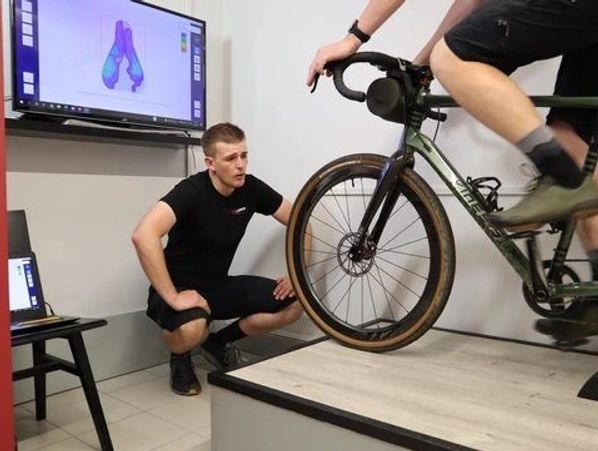 A professional coach assisting a cyclist