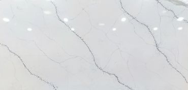 Smooth white marble surface with subtle gray veining and light reflections.