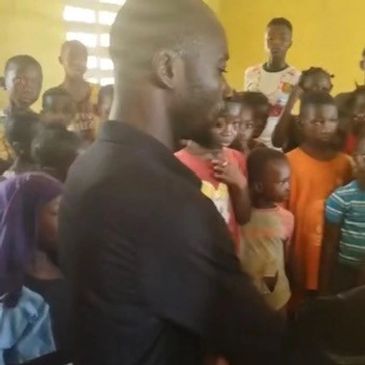 Kids in Sierra Leone classroom with male teacher