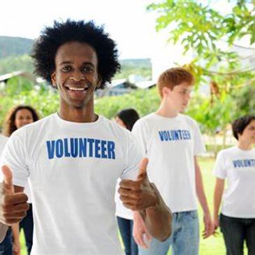 male volunteer holding two thumbs up