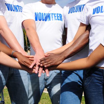 volunteer group in a circle with hands end