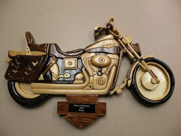 Decorative wooden motorcycle wall plaque with Christmas message.
