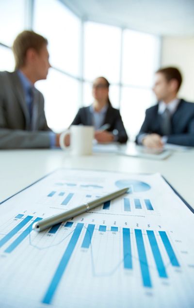 Business document on background of employees planning work at meeting