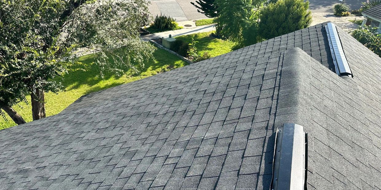 black roof installed on residential home with black metal ridge vents
