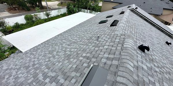 dark grey roof and white flat roof on residential home
