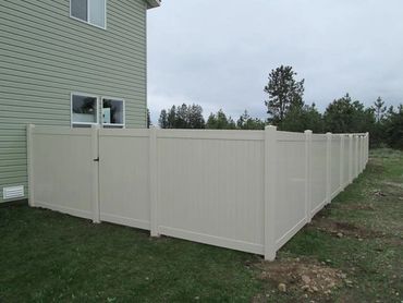 Tan vinyl privacy fence