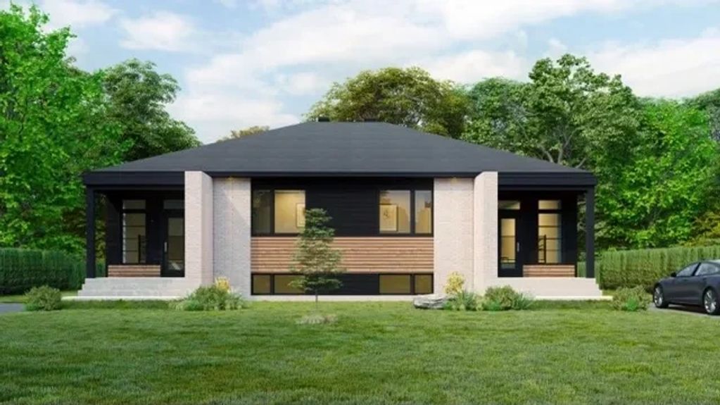 Maison moderne à un étage avec façade noire et beige.