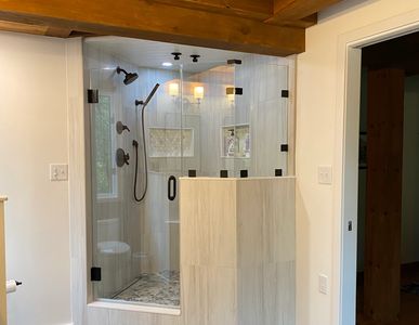 Glass shower enclosure with custom angled glass
