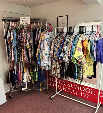 Colorful scrubs for scholars available for free on racks.
