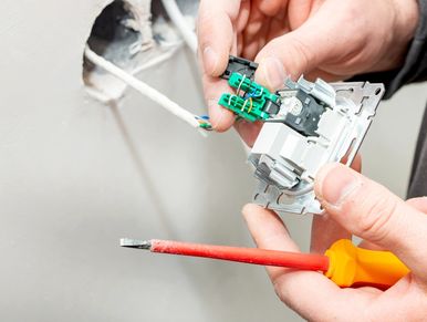 process of installing an internal socket for Internet access on a background of white gypsum wall