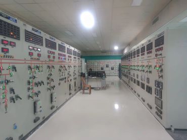 Control room with multiple panels and monitoring equipment.