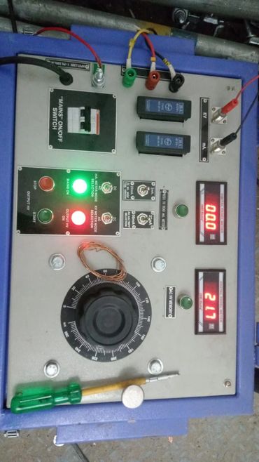 Control panel with switches, dials, meters, and indicator lights.