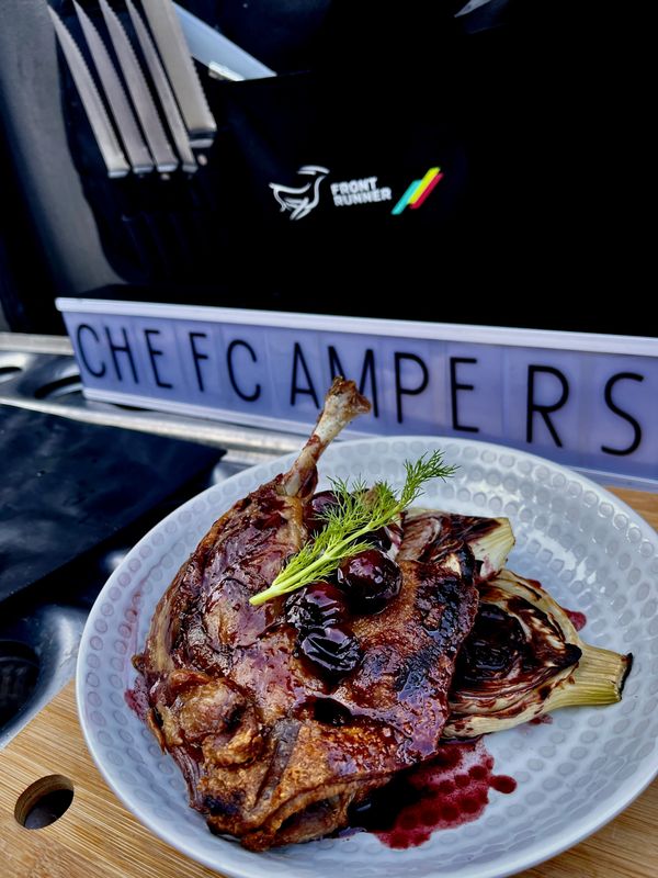 Confit of Duck with charred fennel and cherry sauce with a chefcampers sign