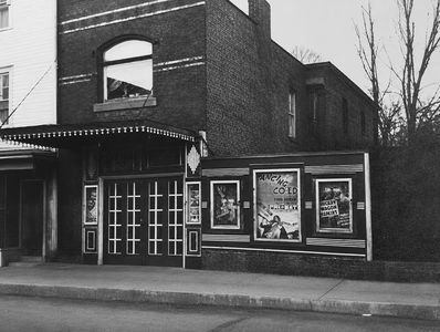 Black and white photo of a vintage movie theater exterior.