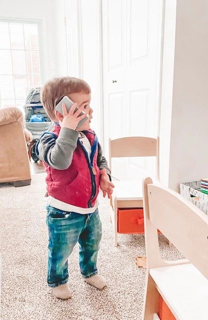 Little boy talking on a pretend phone