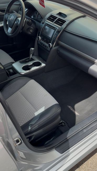 Clean interior of a Toyota Camry with gray seats and modern dashboard.