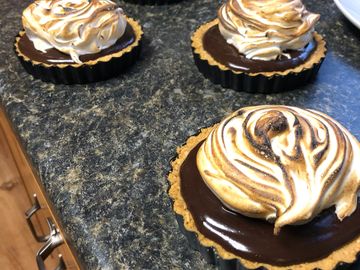 S'mores tarts with a mound of toasted marshmallow on top