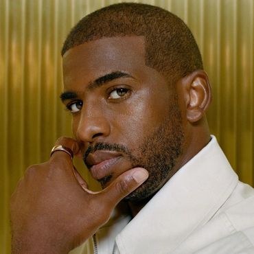 Close-up portrait of a man with a thoughtful expression and a ring on his finger.