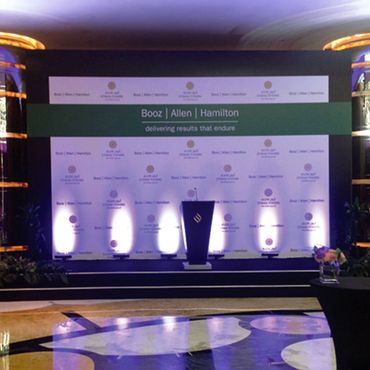 Stage with step and repeat logo backdrop.