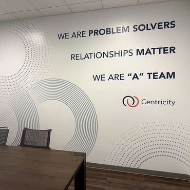 Large oversized and interwoven circles on a wall with Centricity values on the right side.