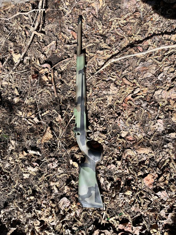 CZ AL 600 with M81 cerakote camo pattern laying in leaves.