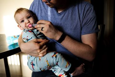 giving baby medicine Nashville documentary photographer