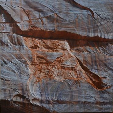 Rock formation resembling the head of a fox or wolf in reddish and gray hues.