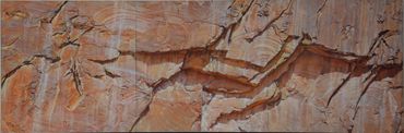Close-up of textured, layered rock formations in earthy tones.