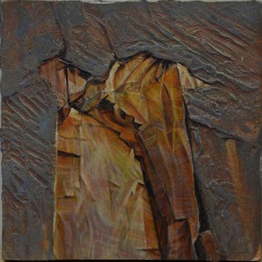 Close-up of textured, layered rock formation with warm brown and orange hues.