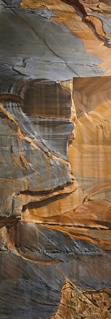 Close-up of colorful layered rock formations in a canyon.