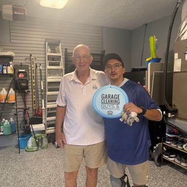 A picture of a garage cleaning guys member standing with client after garage makeover