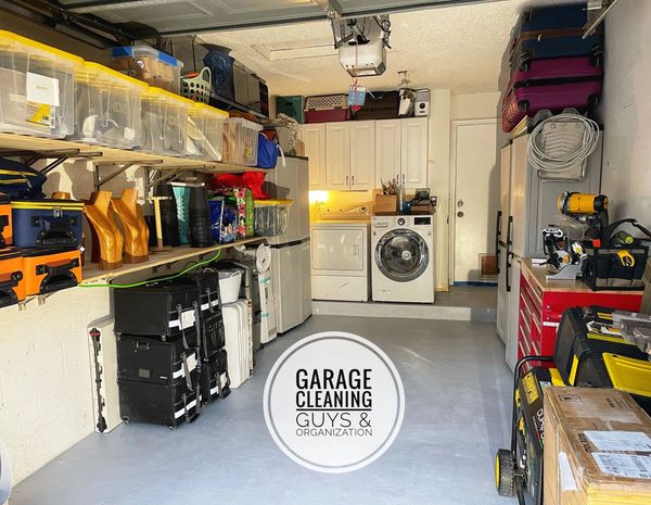 A garage with shelving and a painted floor by garage makeover guys