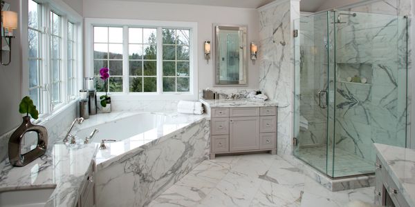 Calcutta marble bathroom with marble shower and marble edged bath