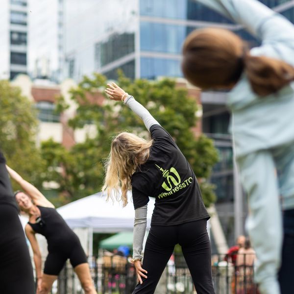 Group of people stretching at a park in Toronto