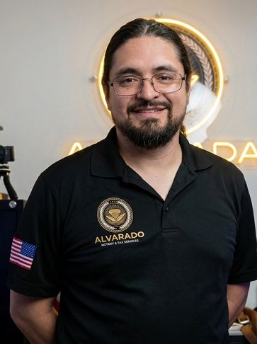 Man wearing glasses and a black polo with American flag and business logo.