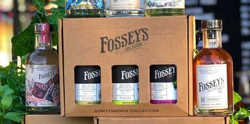 Display of Fossey's Gin bottles and Quintessence Collection packaging.